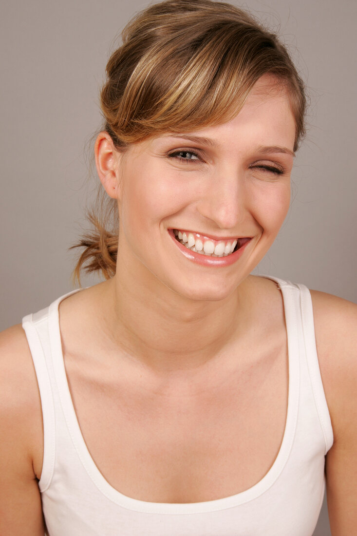 Portrait of Charlotte woman with blonde hair winking, smiling