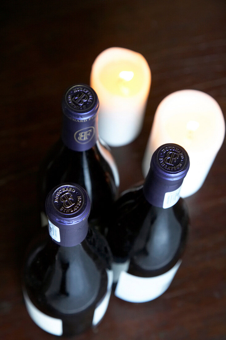 Close-up of three bottles of red wine on table, Bouchard Finlayson Winery, South Africa