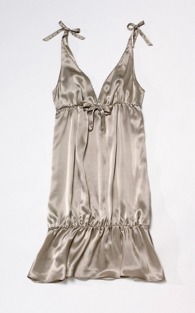 Close-up of gray sating dress on white background