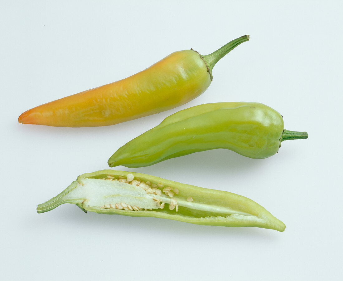 Green and orange chillies on white background, Hungary
