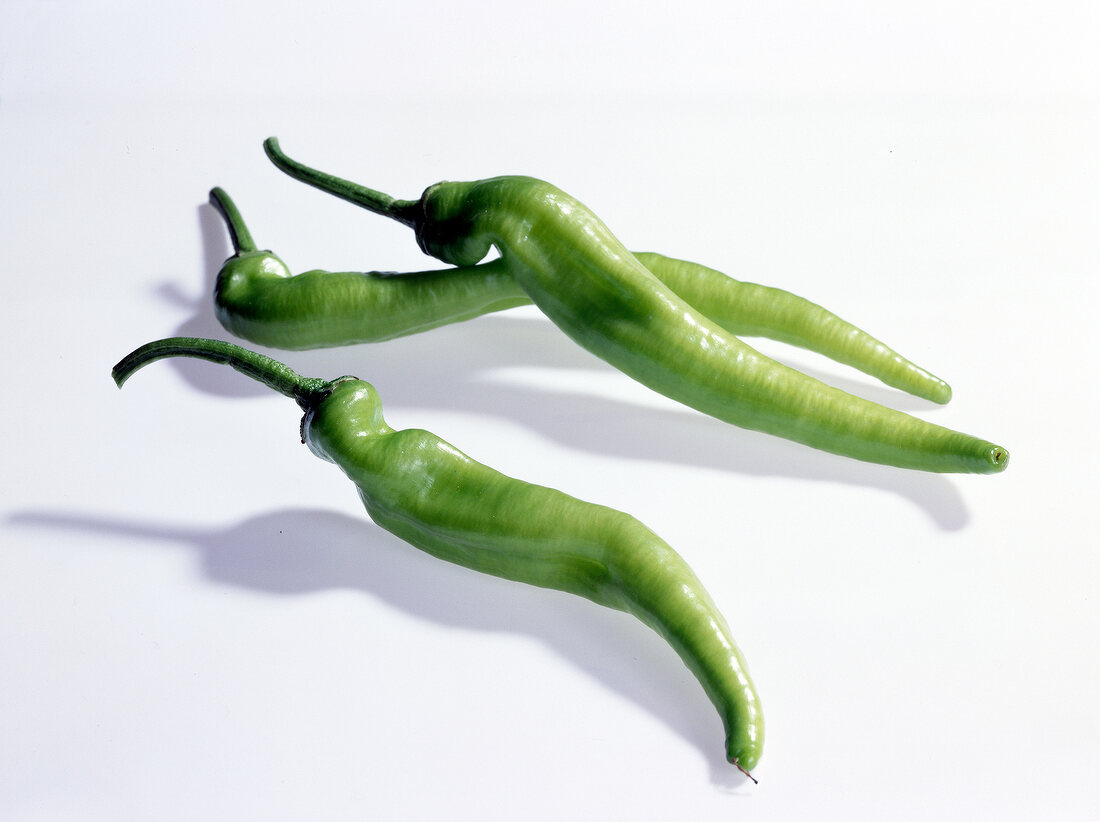 Three green chillies on white background, Turkey