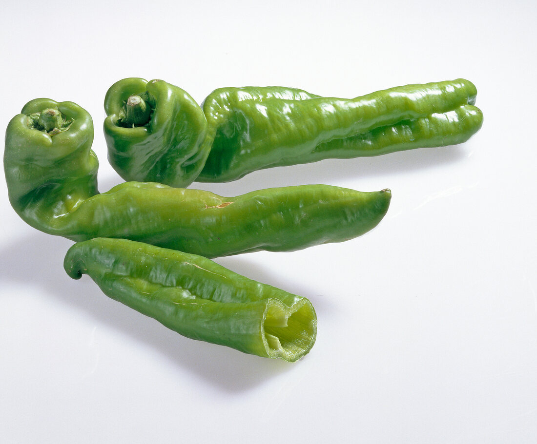 Close-up of green peppers on white background, Spain