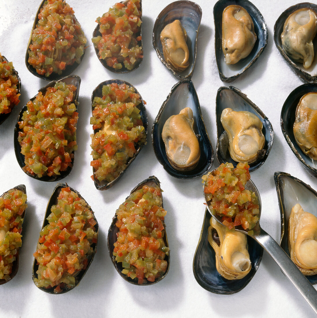 Paprika mixture being placed on mussels, step 4