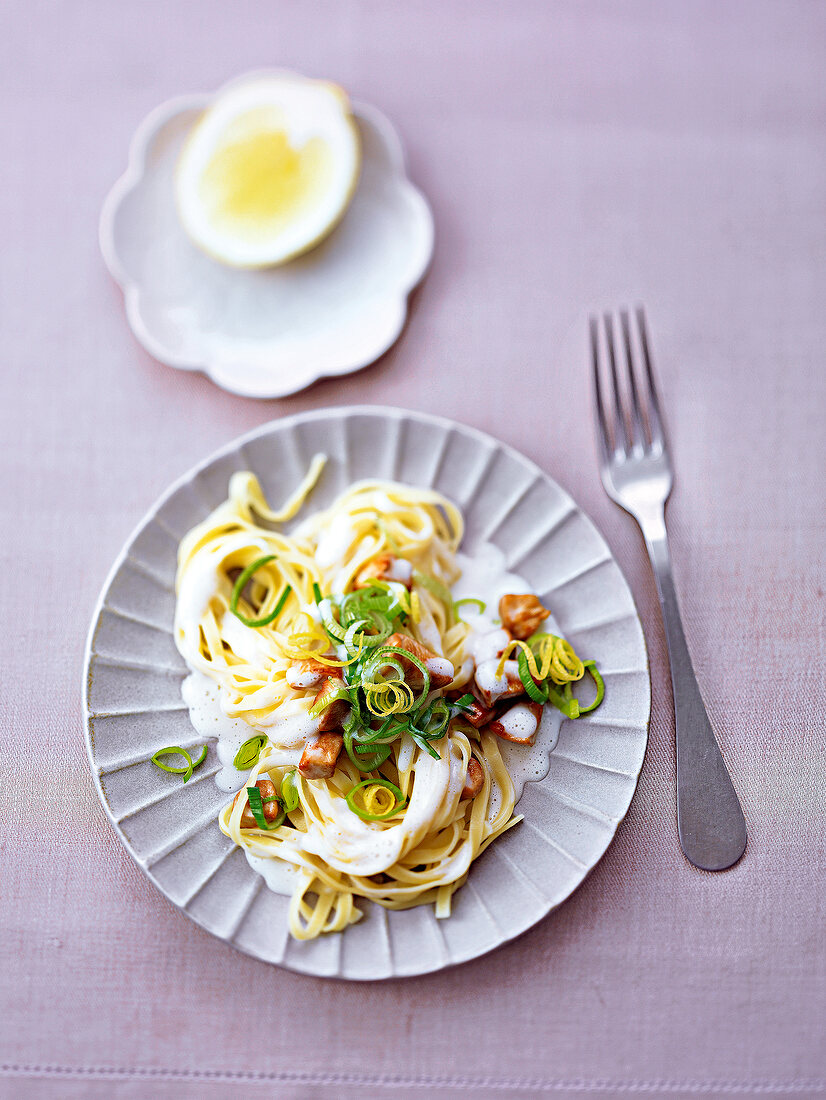 Noodles with chicken and coconut cream on plate