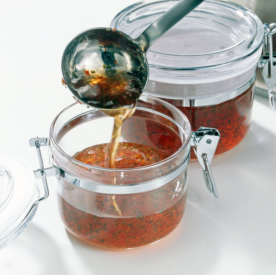 Pouring pepper jelly sauce into glass jars, step 4