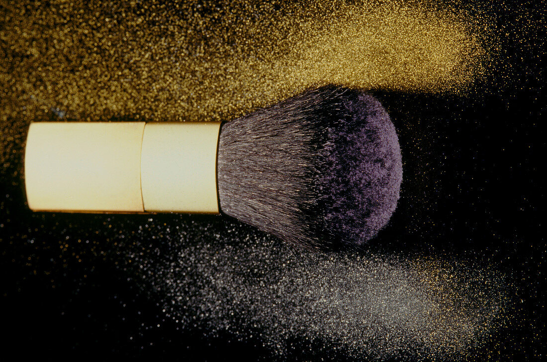 Close-up of make-up blush with gold and silver powder