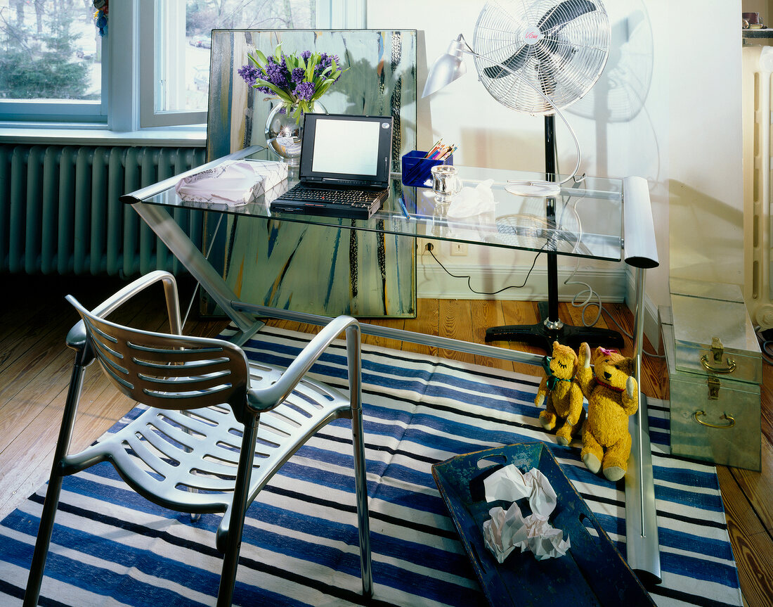 Room with table, chair and blue and white striped carpet