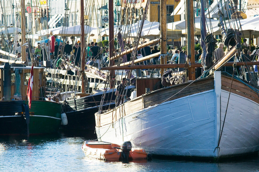 Old sailboats moored at Nyhavn canal in Copenhagen, Denmark