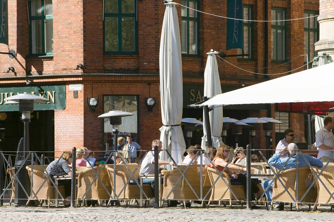 People sitting at cafe in Lilla Torg, Malmo, Sweden