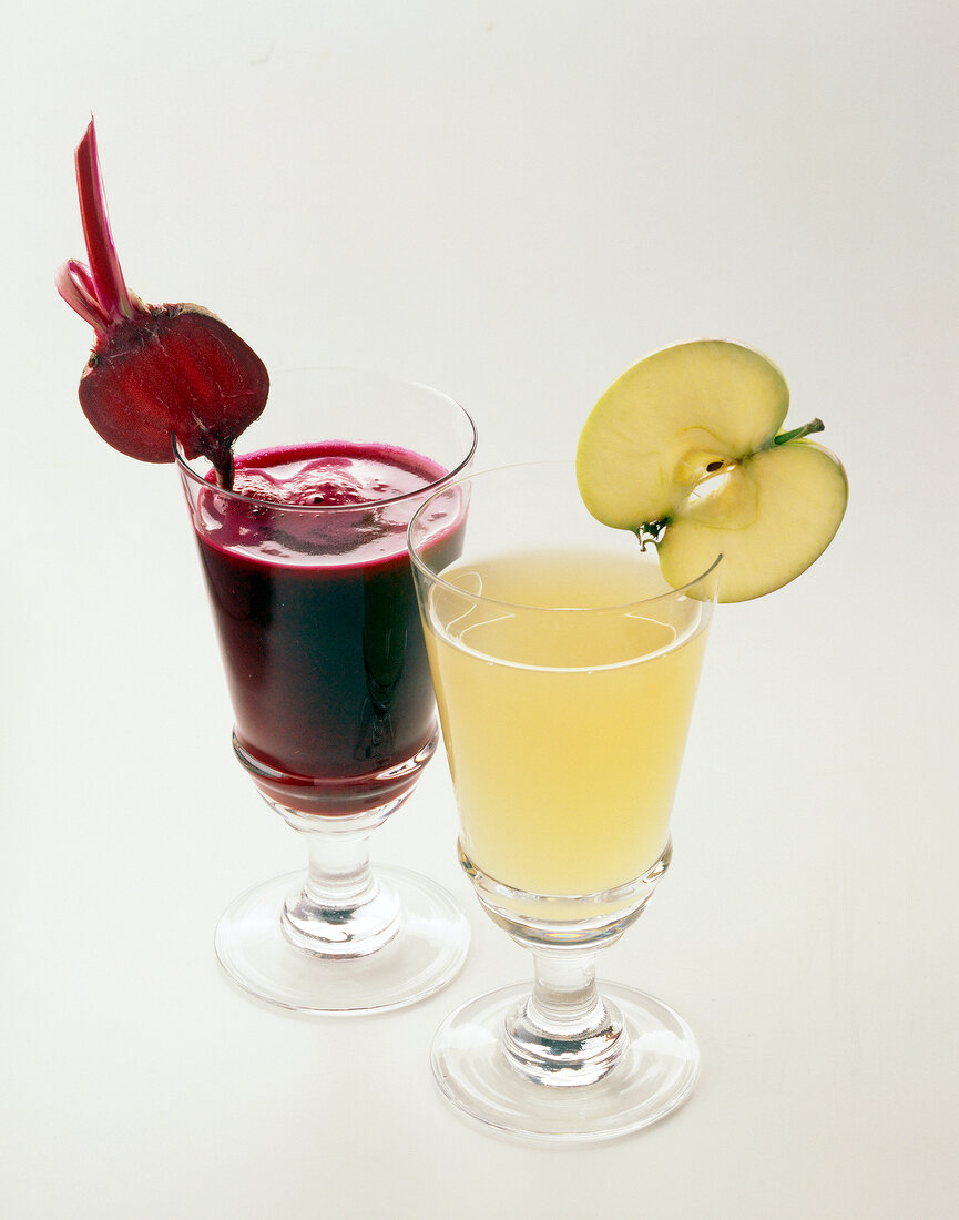 Beetroot-pear juice and apple-celery juice in glasses