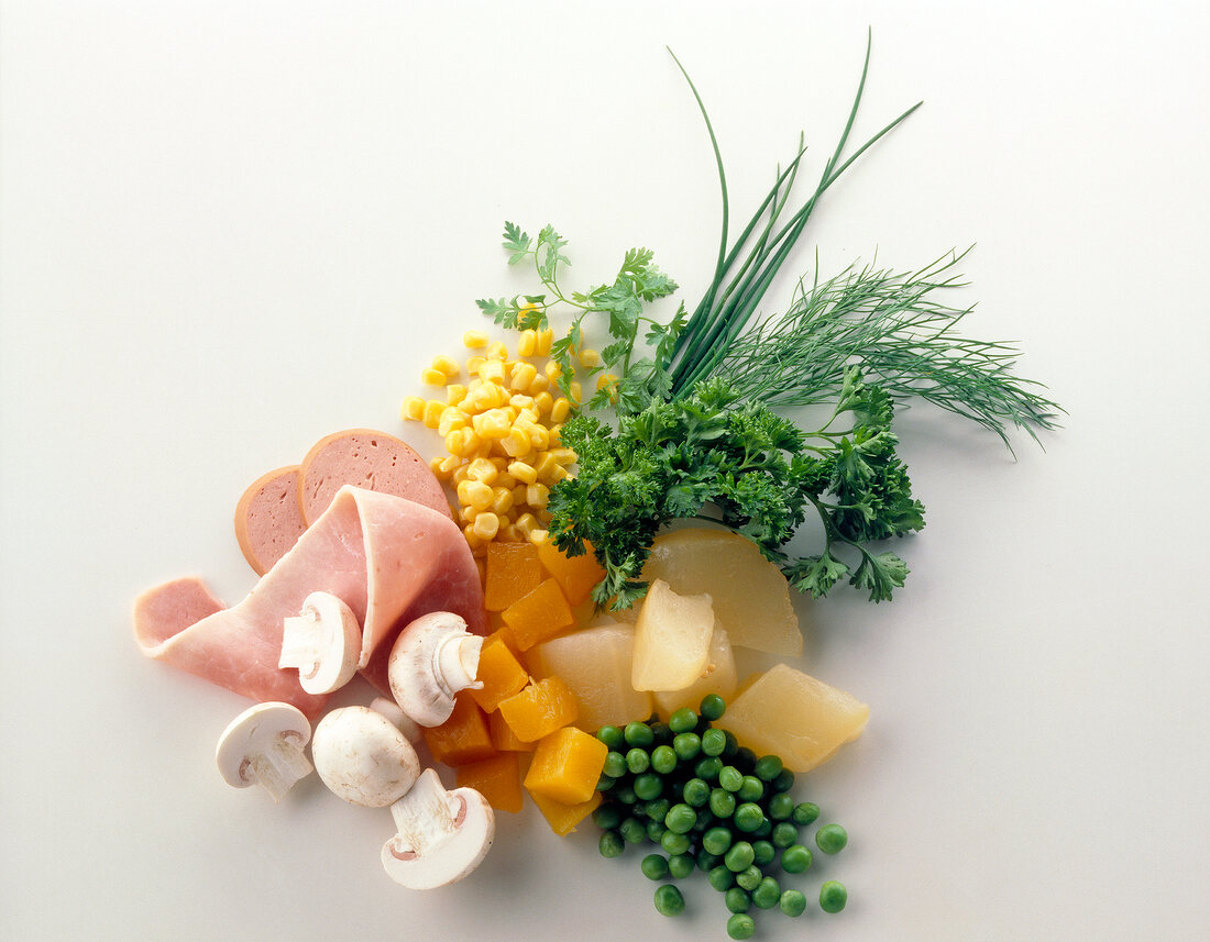 Corn, peas, herbs, mushrooms and sausages on white background, ingredients for pasta salad