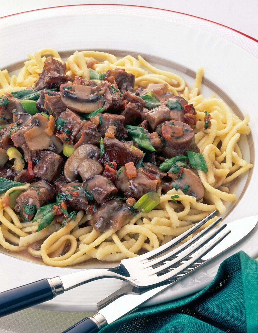 Close-up oxtail ragout with mushrooms on plate