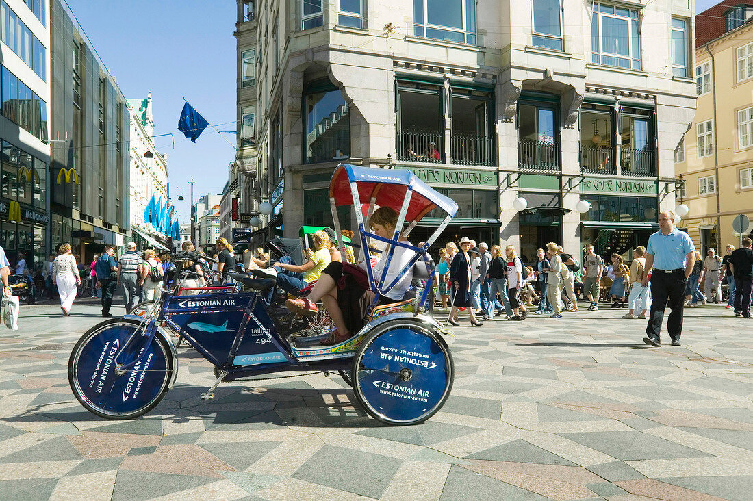 Commuter sitting in pedicab at Amager Square in Copenhagen, Denmark