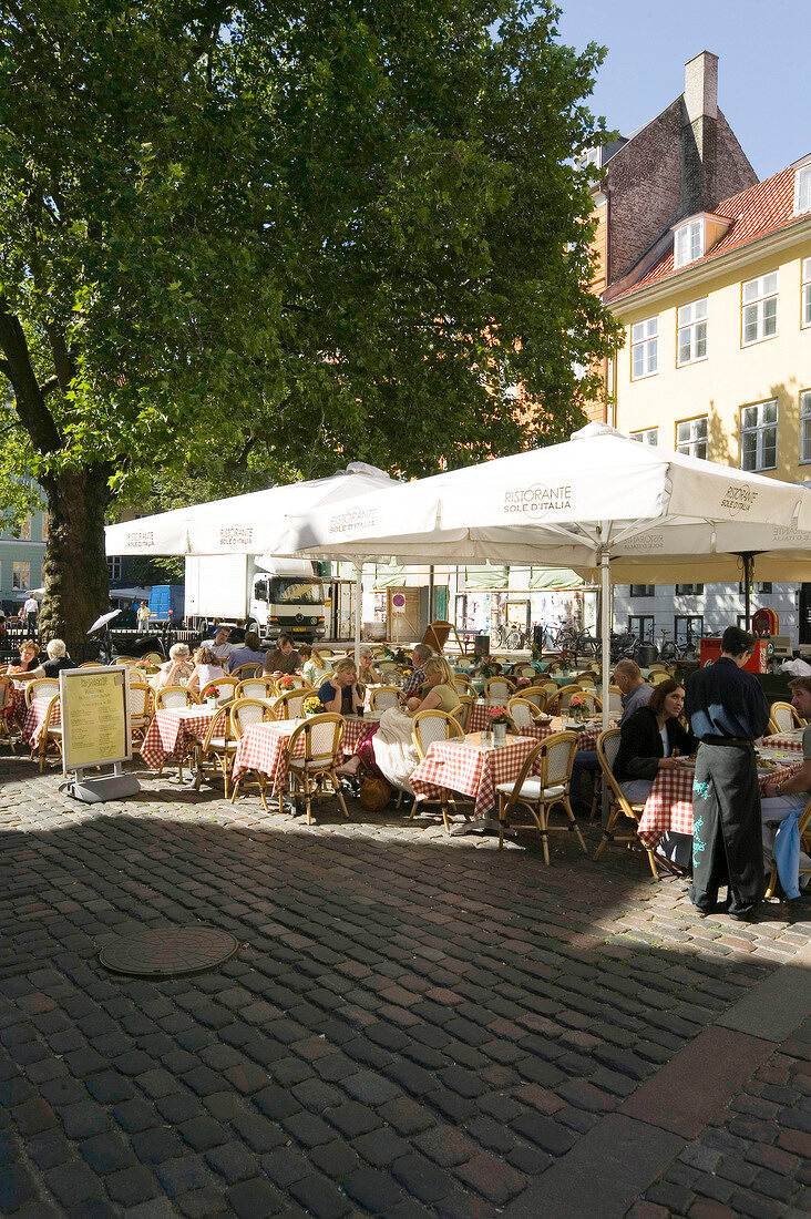 People sitting at Sole d'Italia Restaurant in Grabrodretorv Square, Copenhagen, Denmark