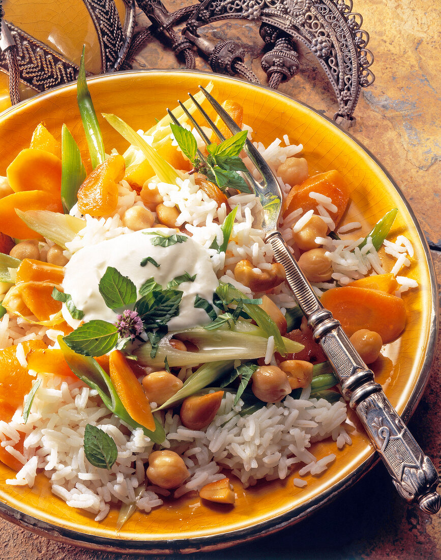 Rice with chickpeas, carrots and ginger on plate