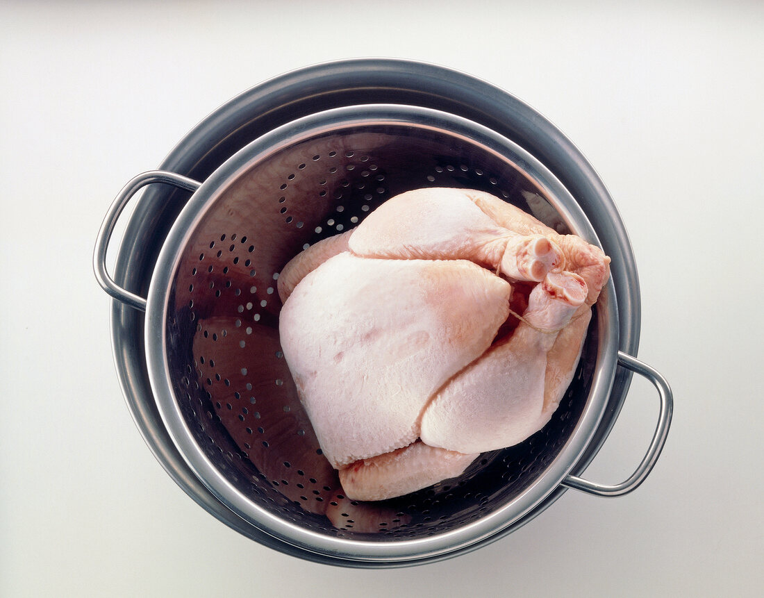 Thawing frozen chicken in strainer