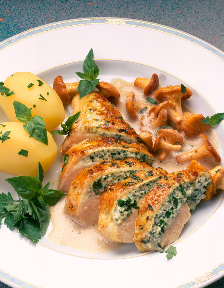 Close-up of chicken poulard filled with cream cheese, potatoes and mushrooms on plate