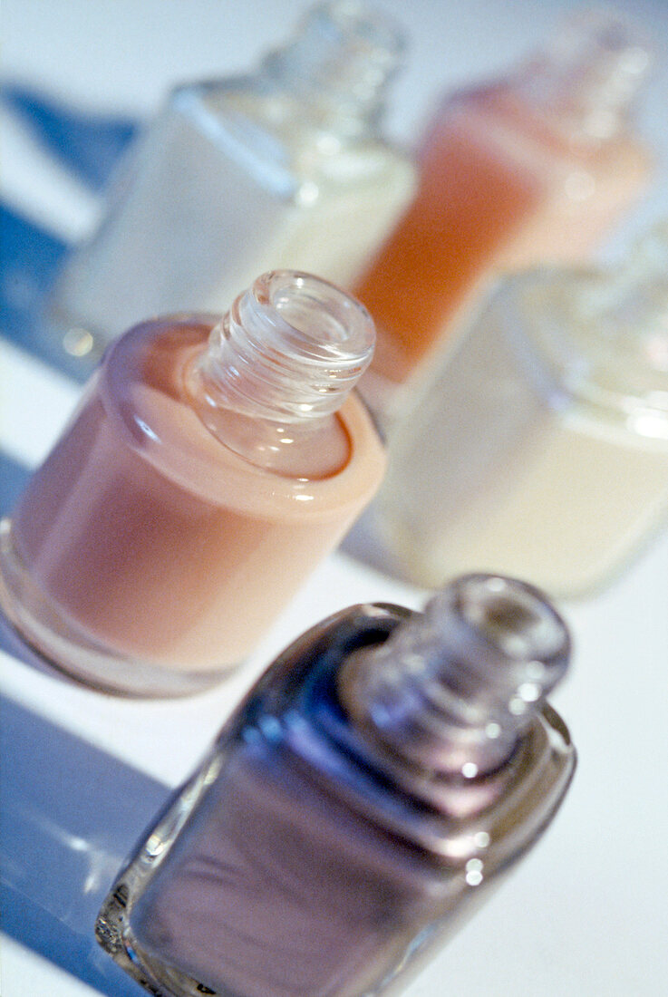 Close-up of various opened nail polish bottles