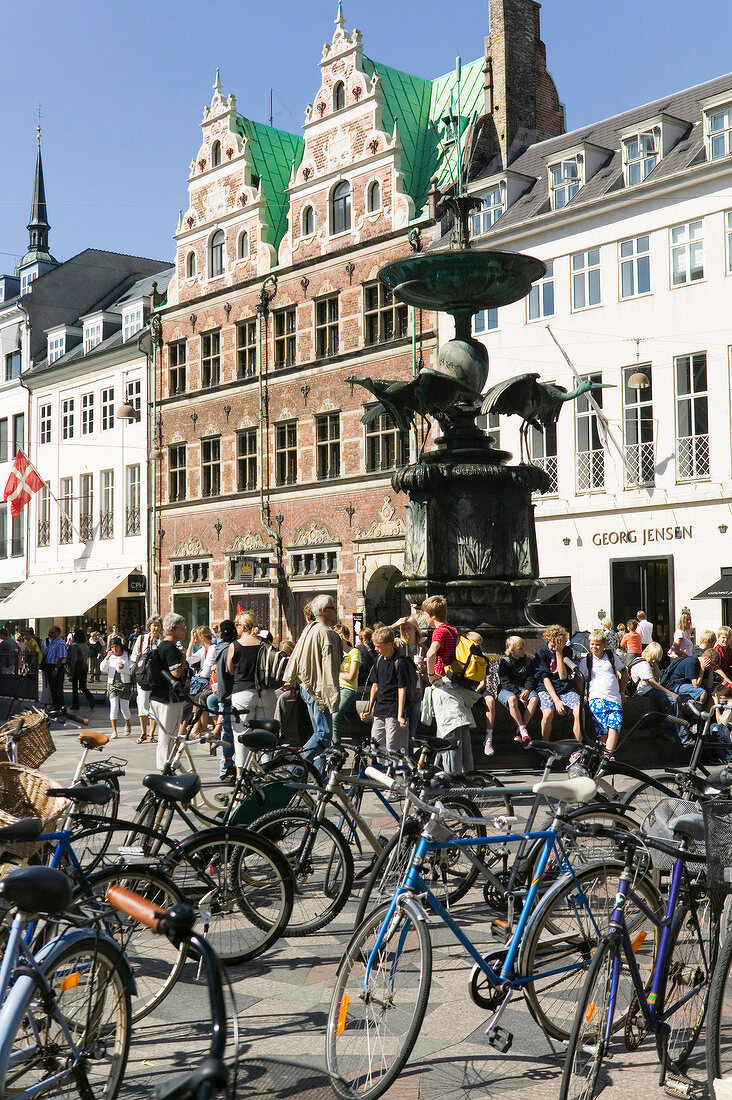 Parked bicycles and fountain at Amager Square in Copenhagen, Denmark