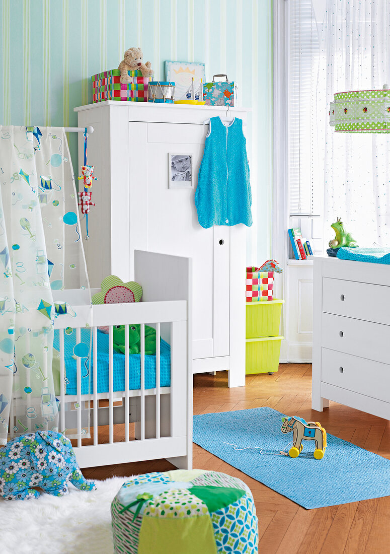 Children's room with cradle, wardrobe, cushion and fur rug