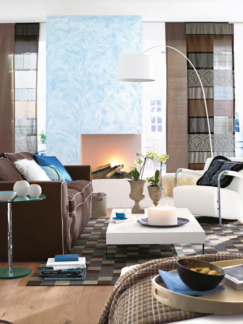 Living room with brown sofa, armchair, carpet and lamp