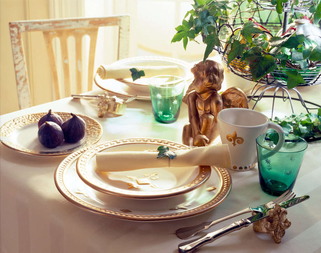 Festively decorated table with dishes, napkin and glasses