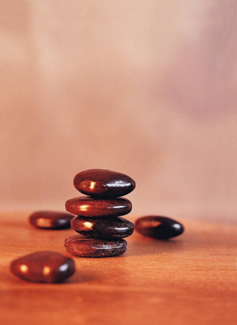 Several smooth pebbles stacked together on table