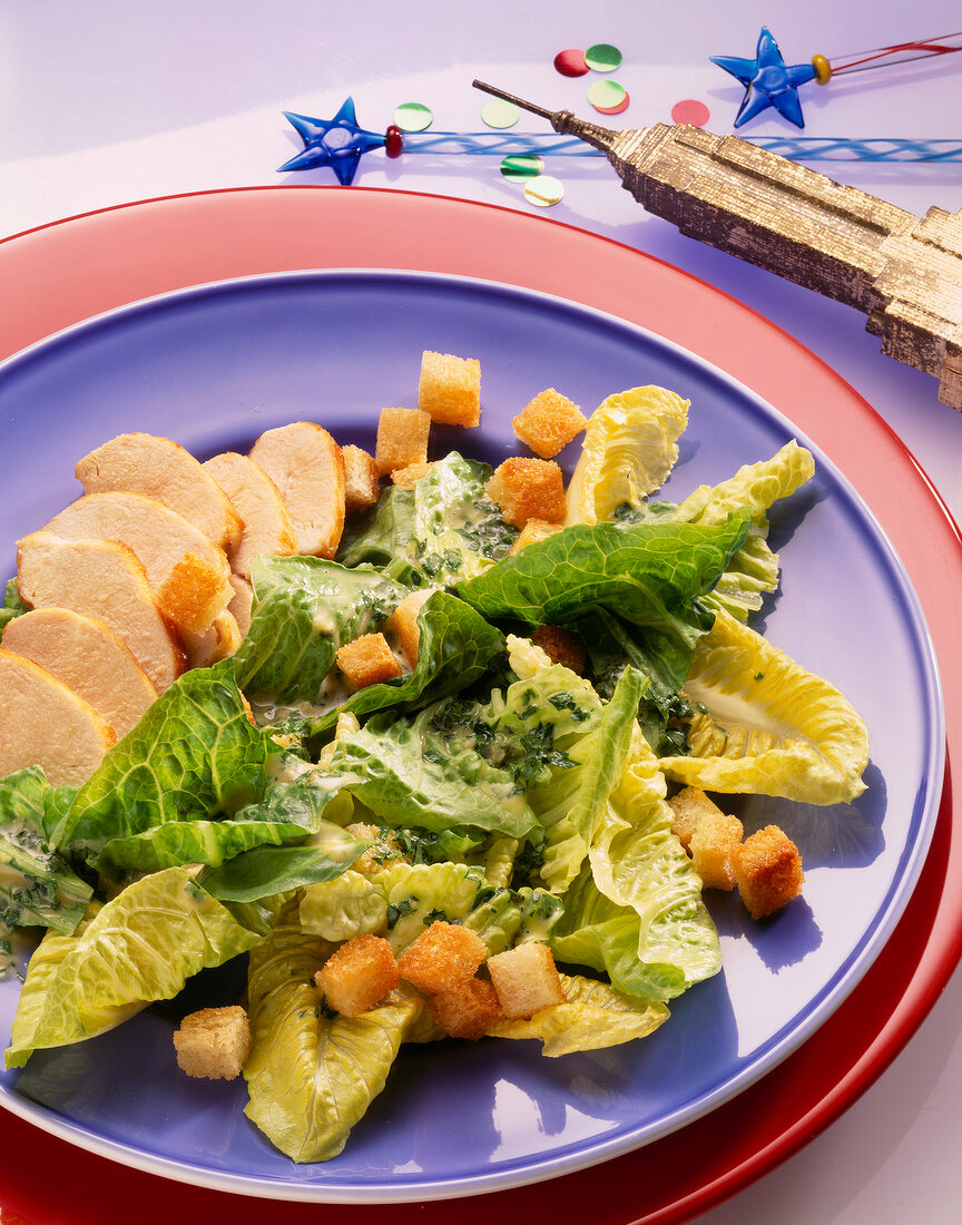 American Caesar's salad with chicken breast and lettuce on plate