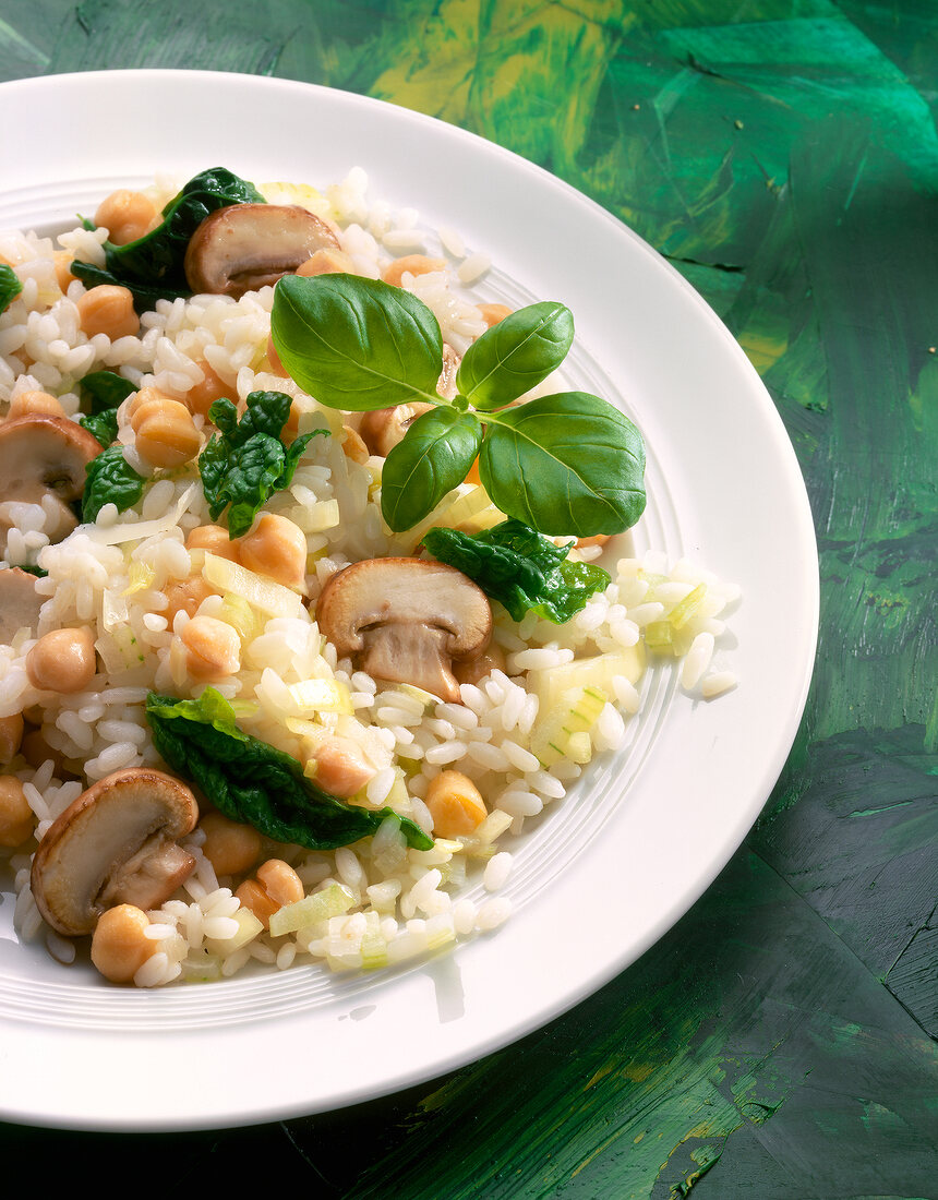 Risotto with spinach and mushrooms on plate