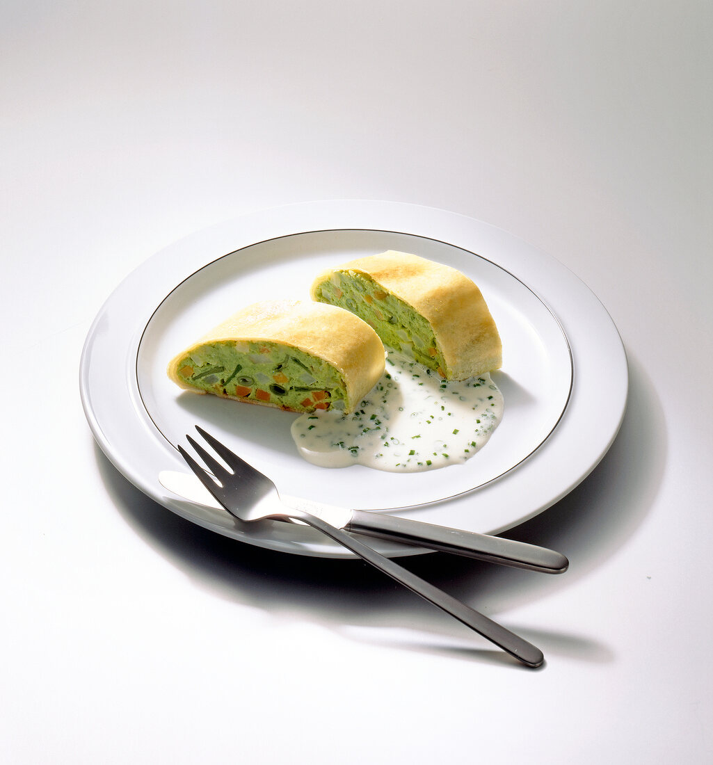 Vegetable strudel and chive sauce on plate