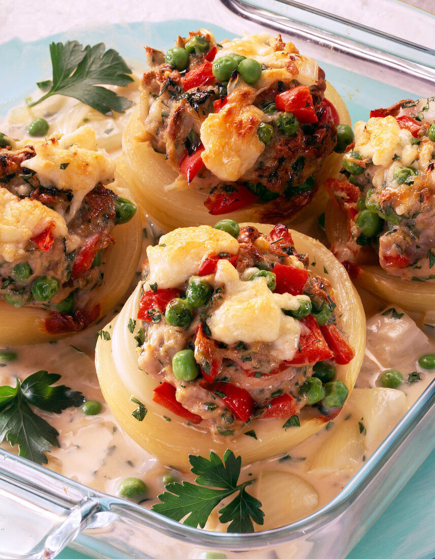 Onions stuffed with sausage meat in glass baking dish