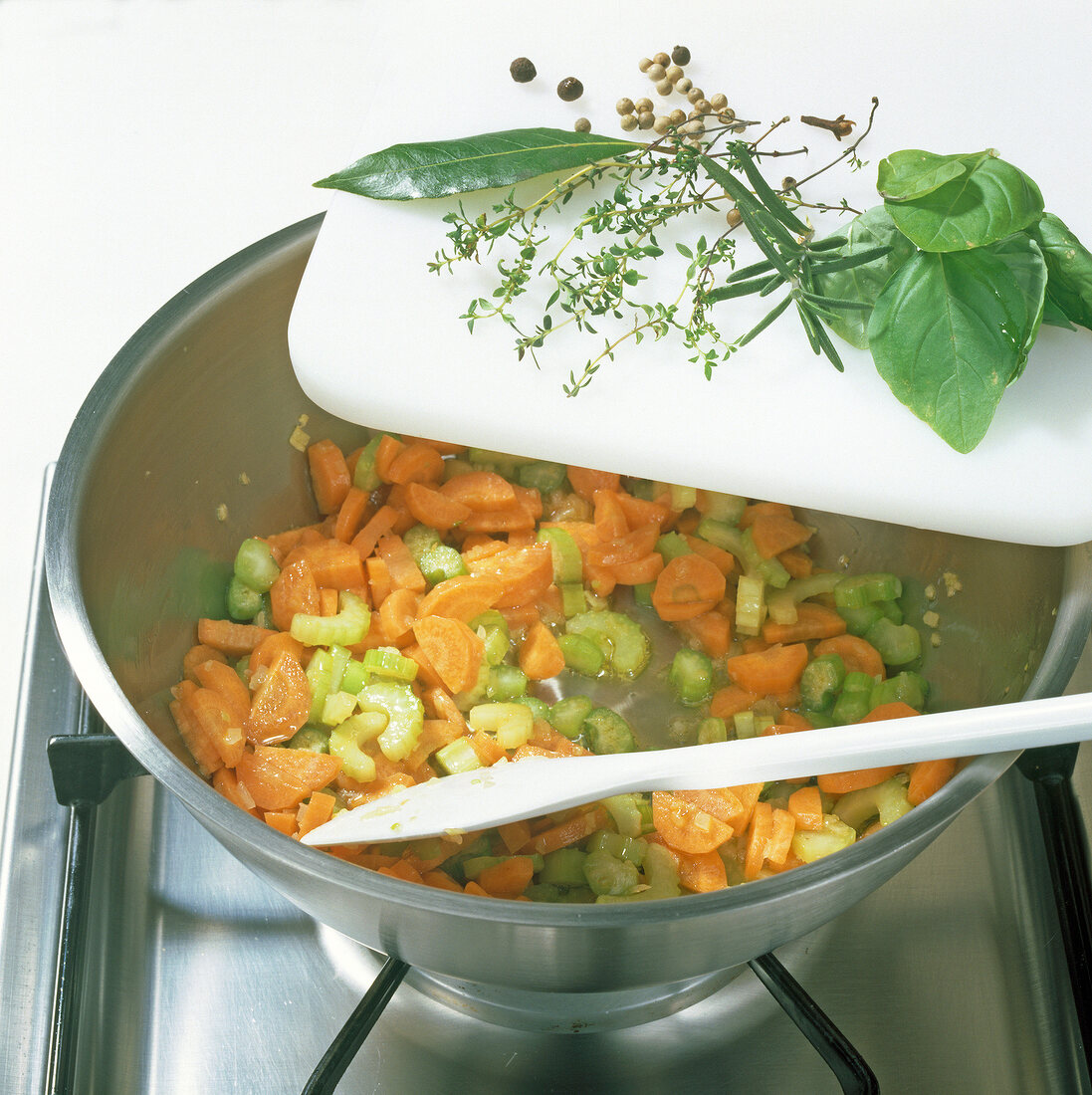 Carrots, onions and celery being cooked in pot