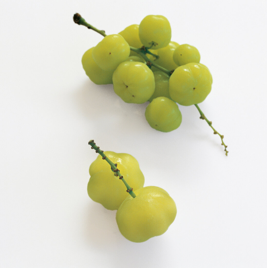 Green gooseberries on white background