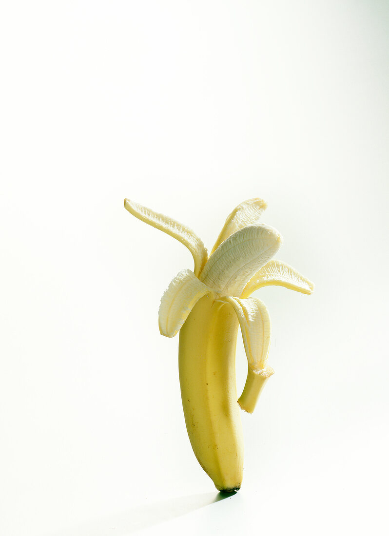 Peeled banana on white background