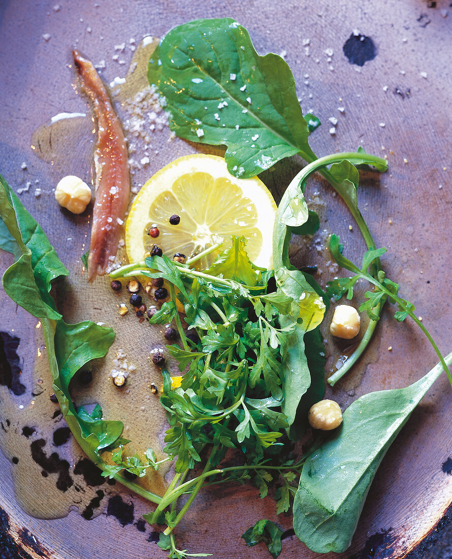 Close-up of salad with lemon, anchovies and herbs