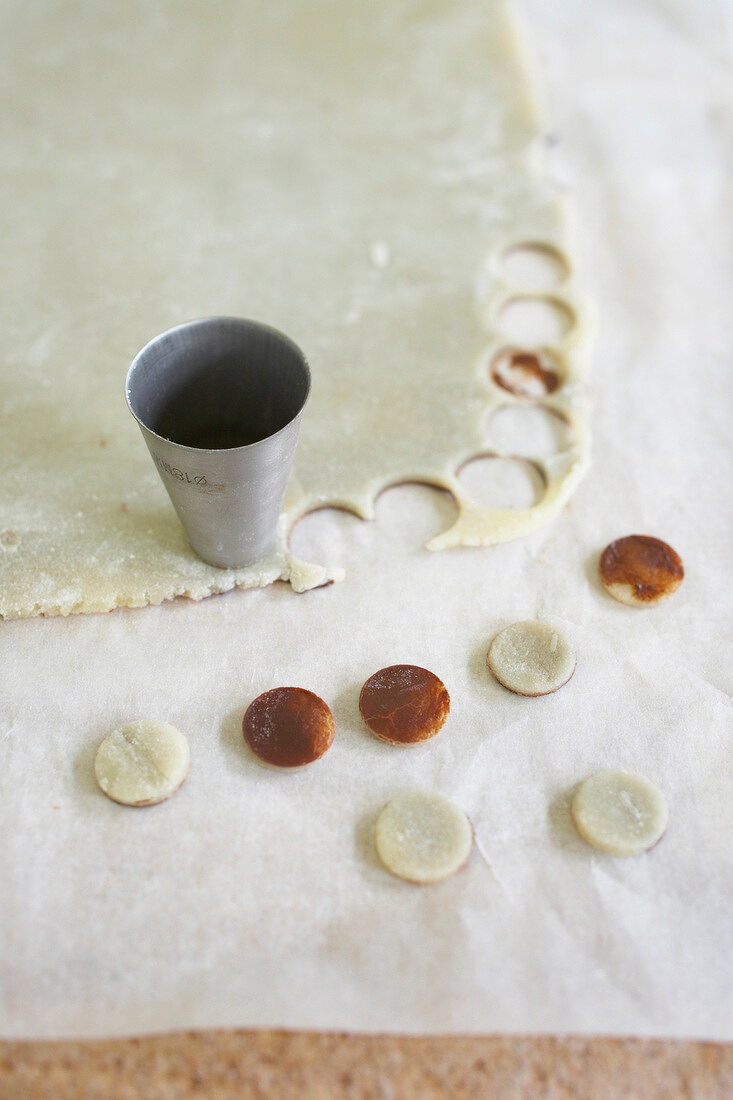 Circle shaped marzipan with chocolate on baking sheet