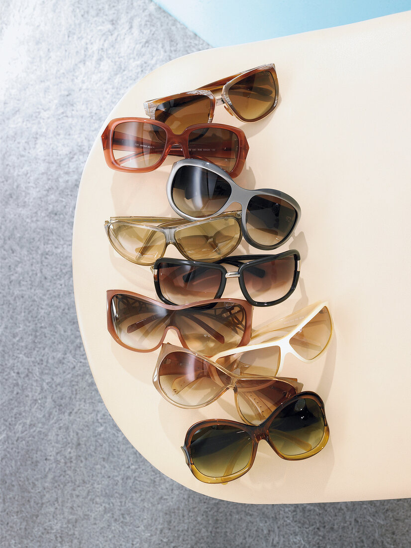 Various sunglasses lying on table