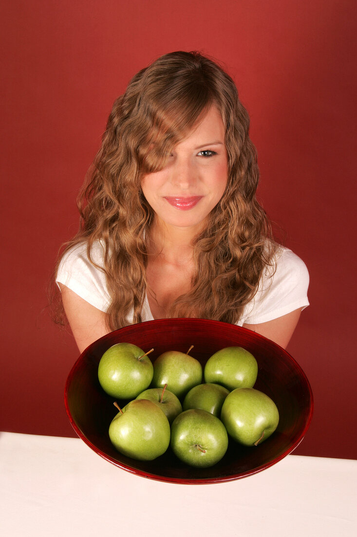 Woman holding bowl of fruits