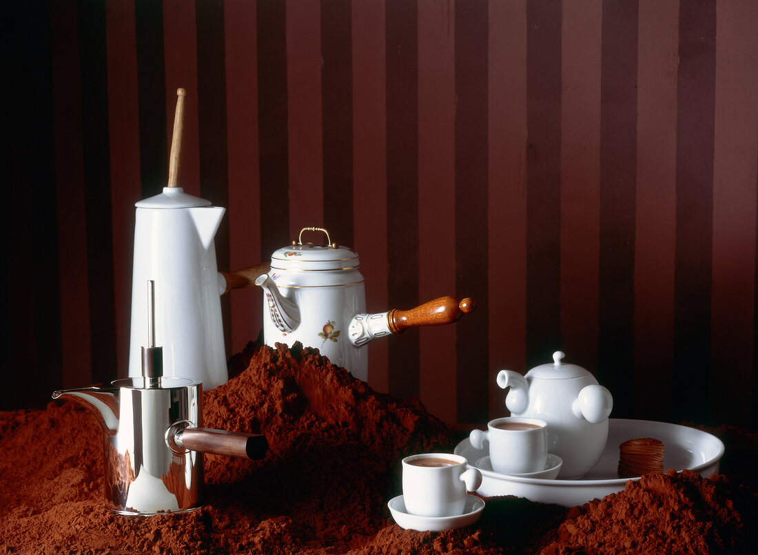 Various pots and utensils with chocolate and coffee around