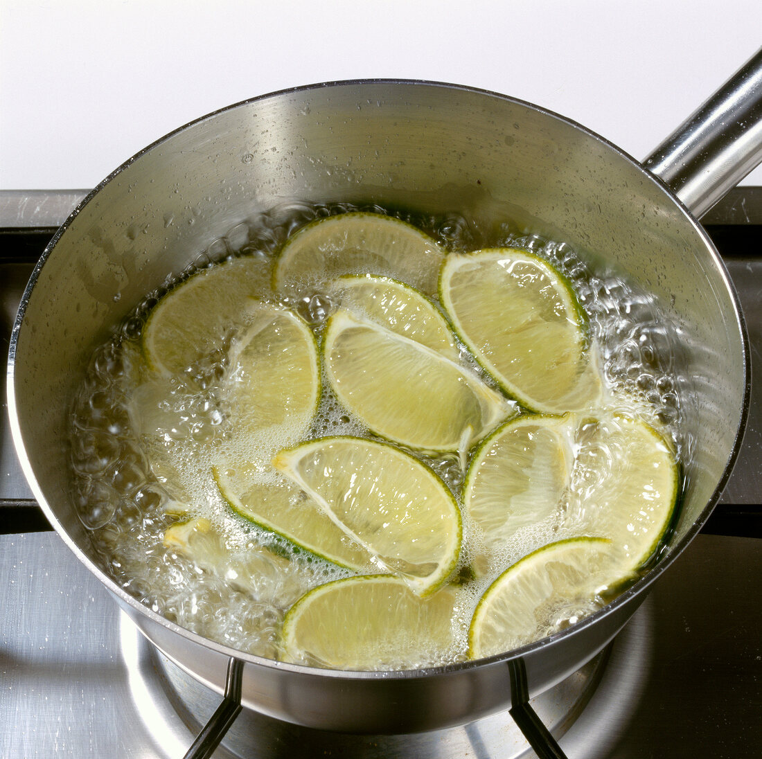 Lime being cooked with water in cooking pot