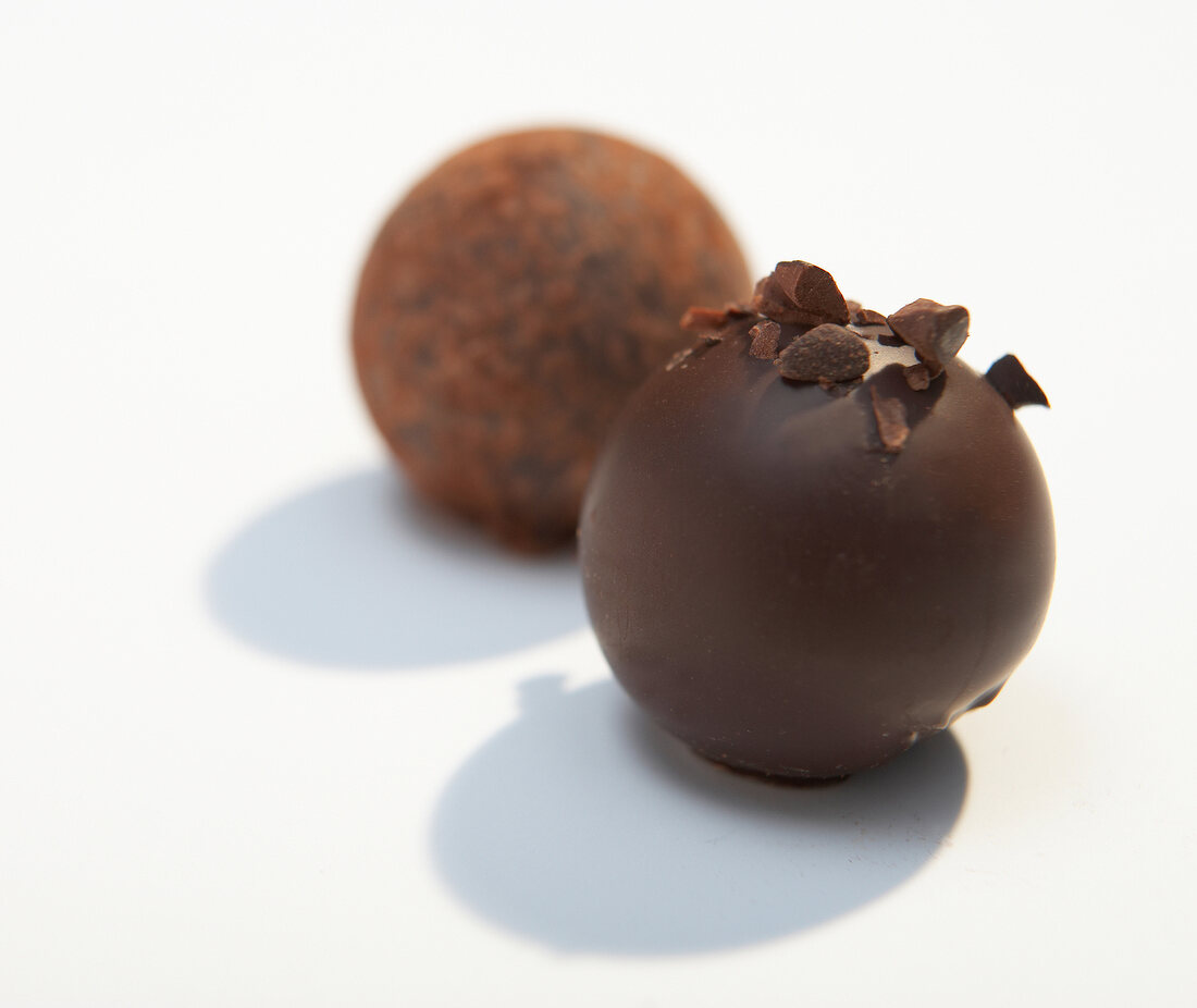 Three round chocolates on white background