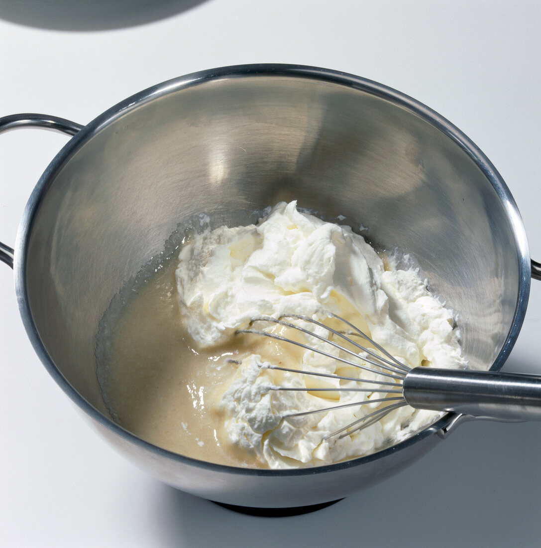 Close-up of custard apple pulp and cream being whisked