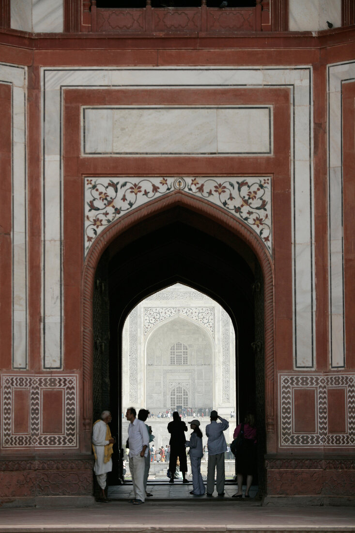 Indien, Agra, Touristen stehen am Eingangsgebäude des Taj Mahal
