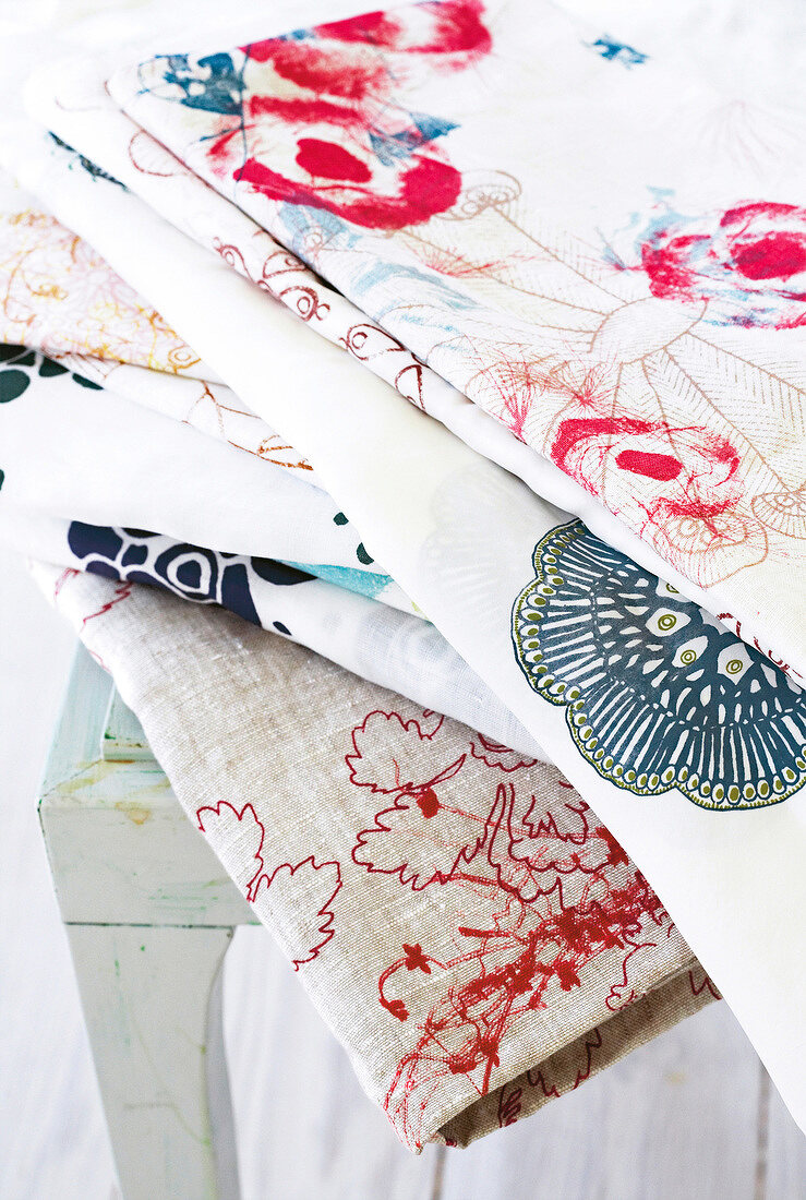 Various floral patterned fabric stacked on table