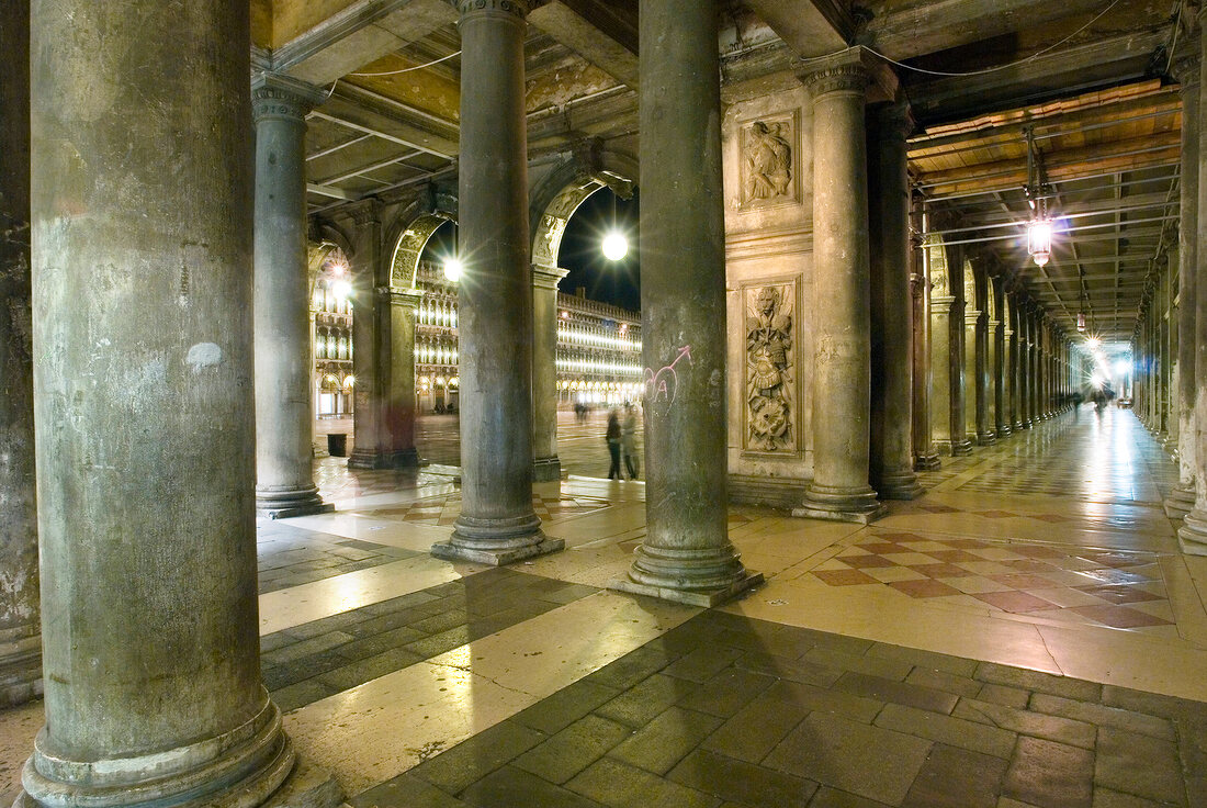 View of arches and columns of St. Mark's Square at night