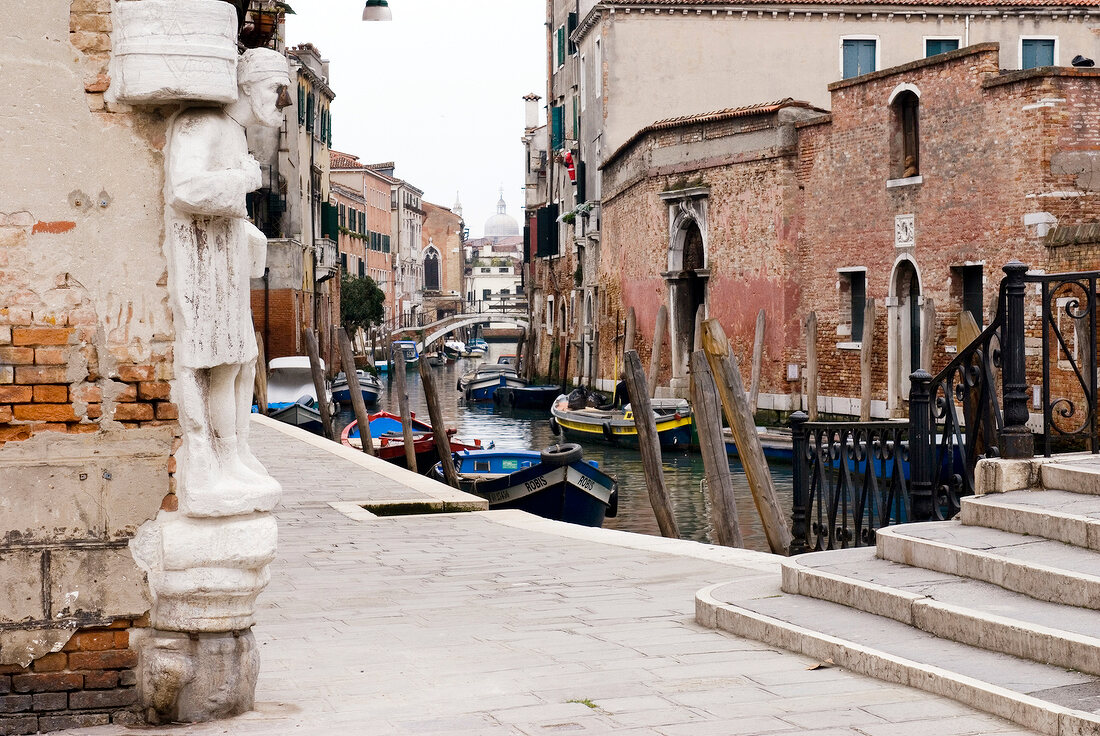 Stone statue of Sior Antonio Rioba on Campo Dei Mori and canal in Venice, Italy