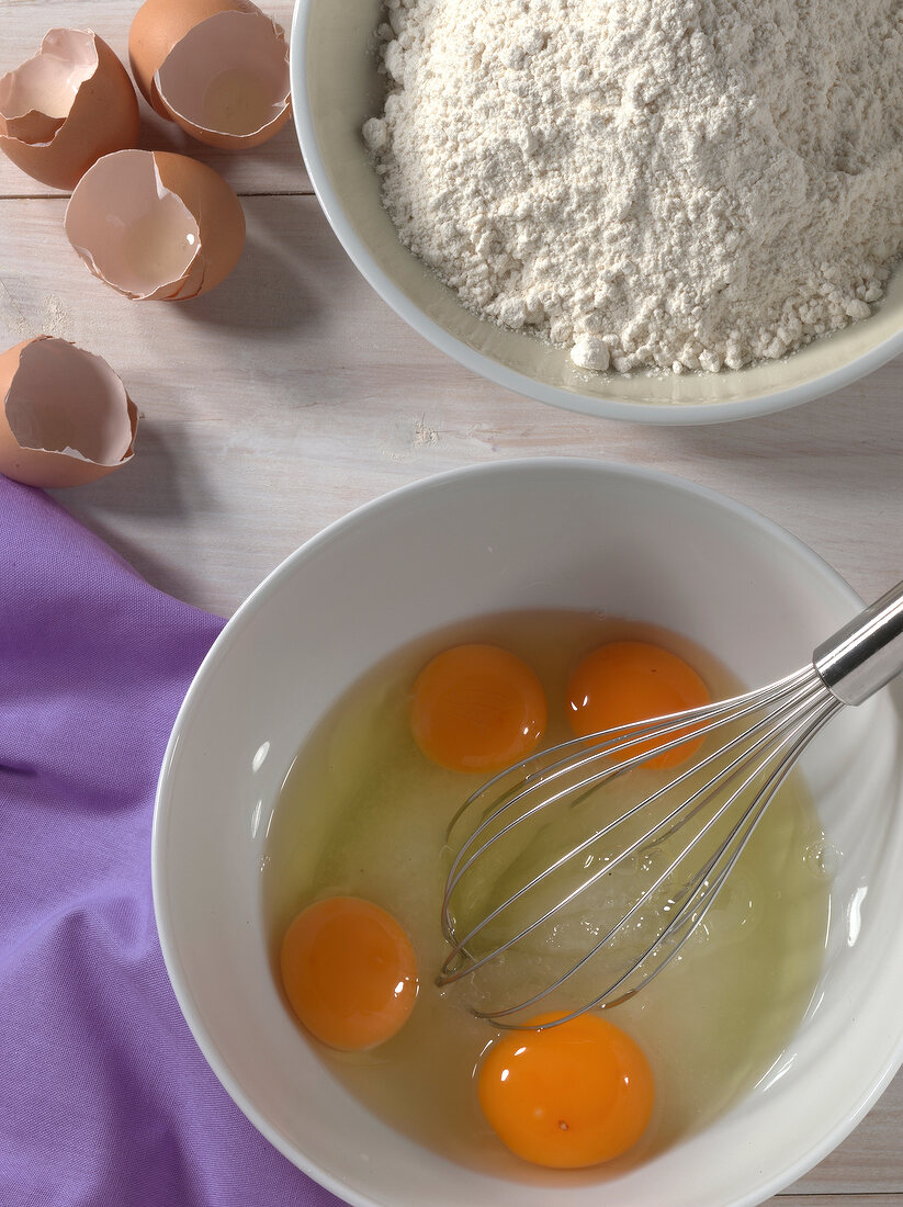 Egg yolks and whisk in bowl for preparation of cake