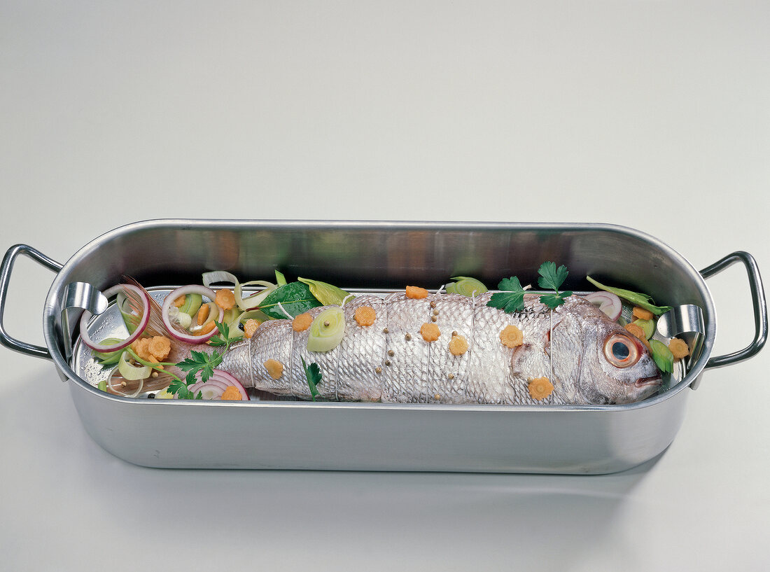 Fish with vegetables in baking dish