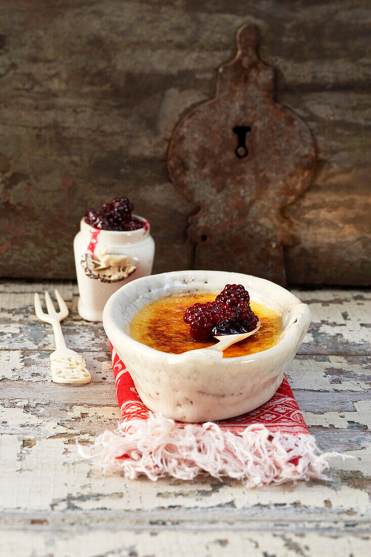 Creme bruleeÃƒÆ’Ã¢â‚¬Å¡Ãƒâ€šÃ‚Â of goat milk cheese with blackberries in bowls