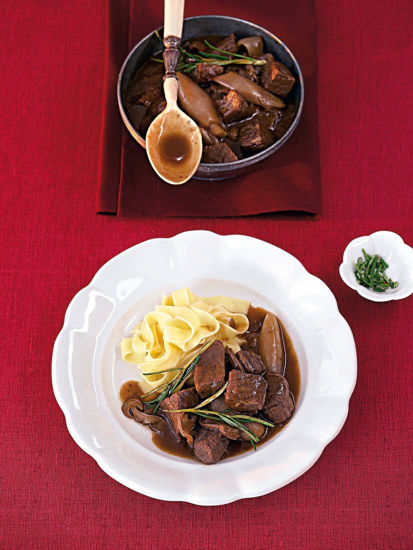 Beef stew with shallots on plate